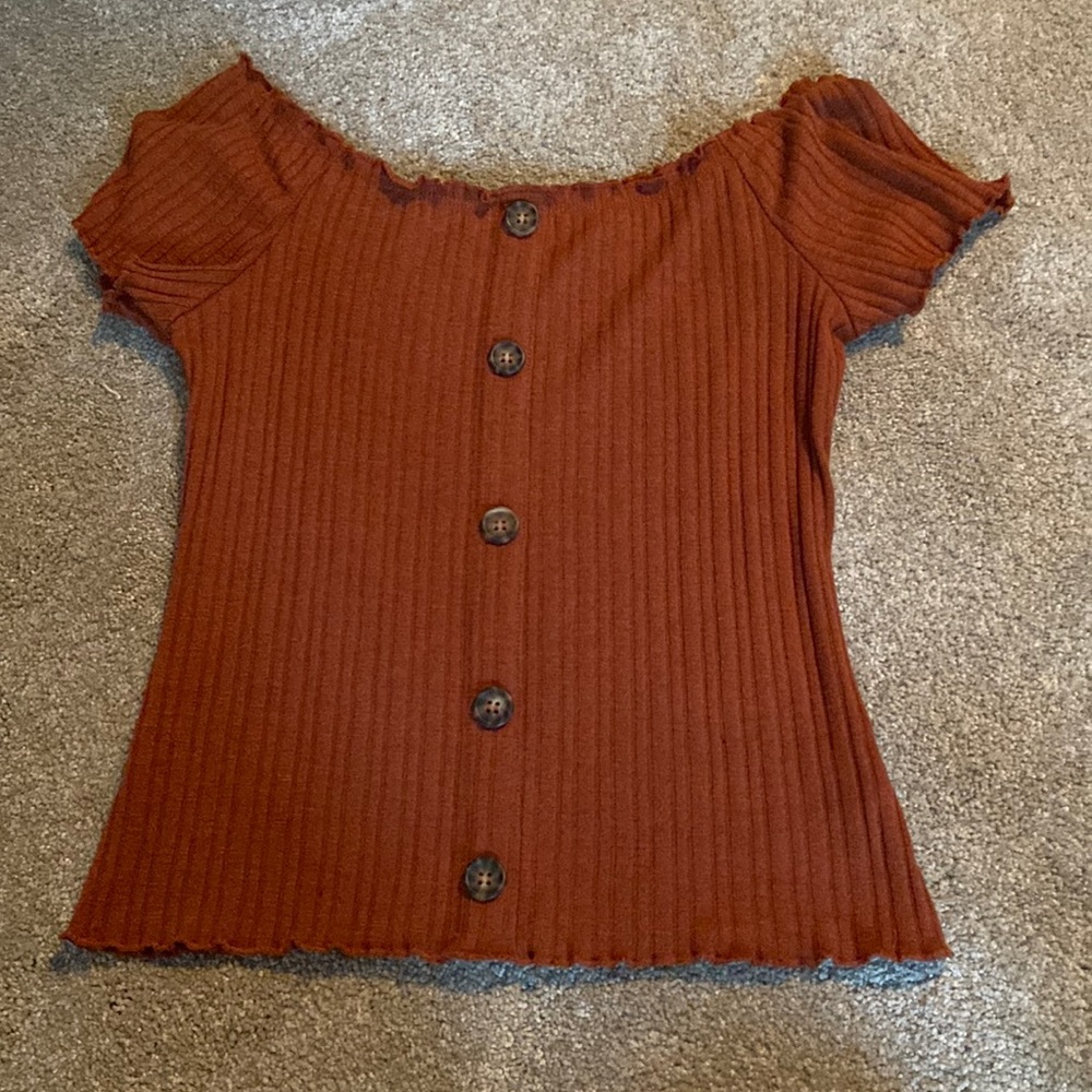Ribbed, burnt orange color shirt with 5 buttons down the front